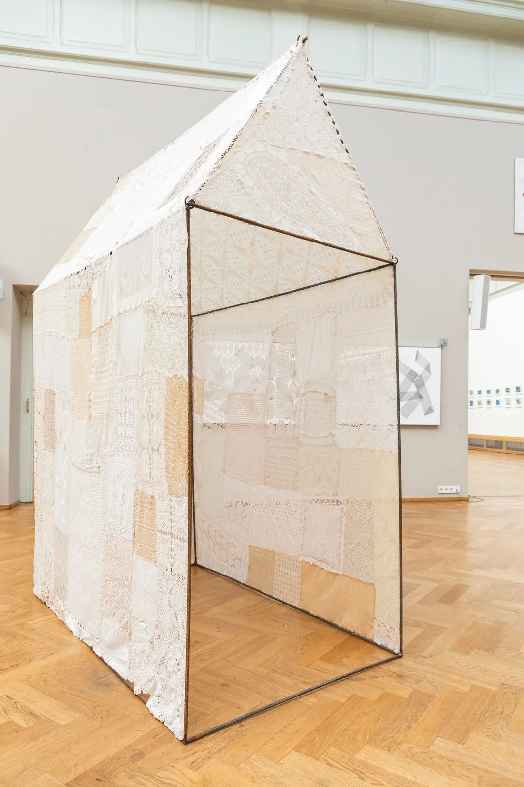 Hestia, a house-shaped steel structure covered in translucent lace textiles