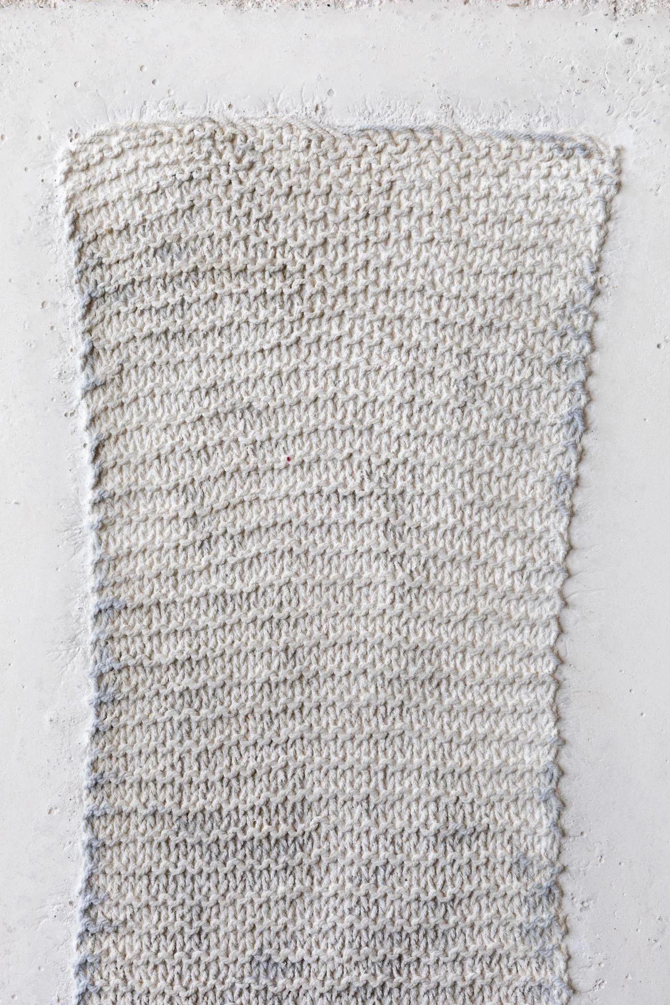 Textured rectangular surface in pale grey