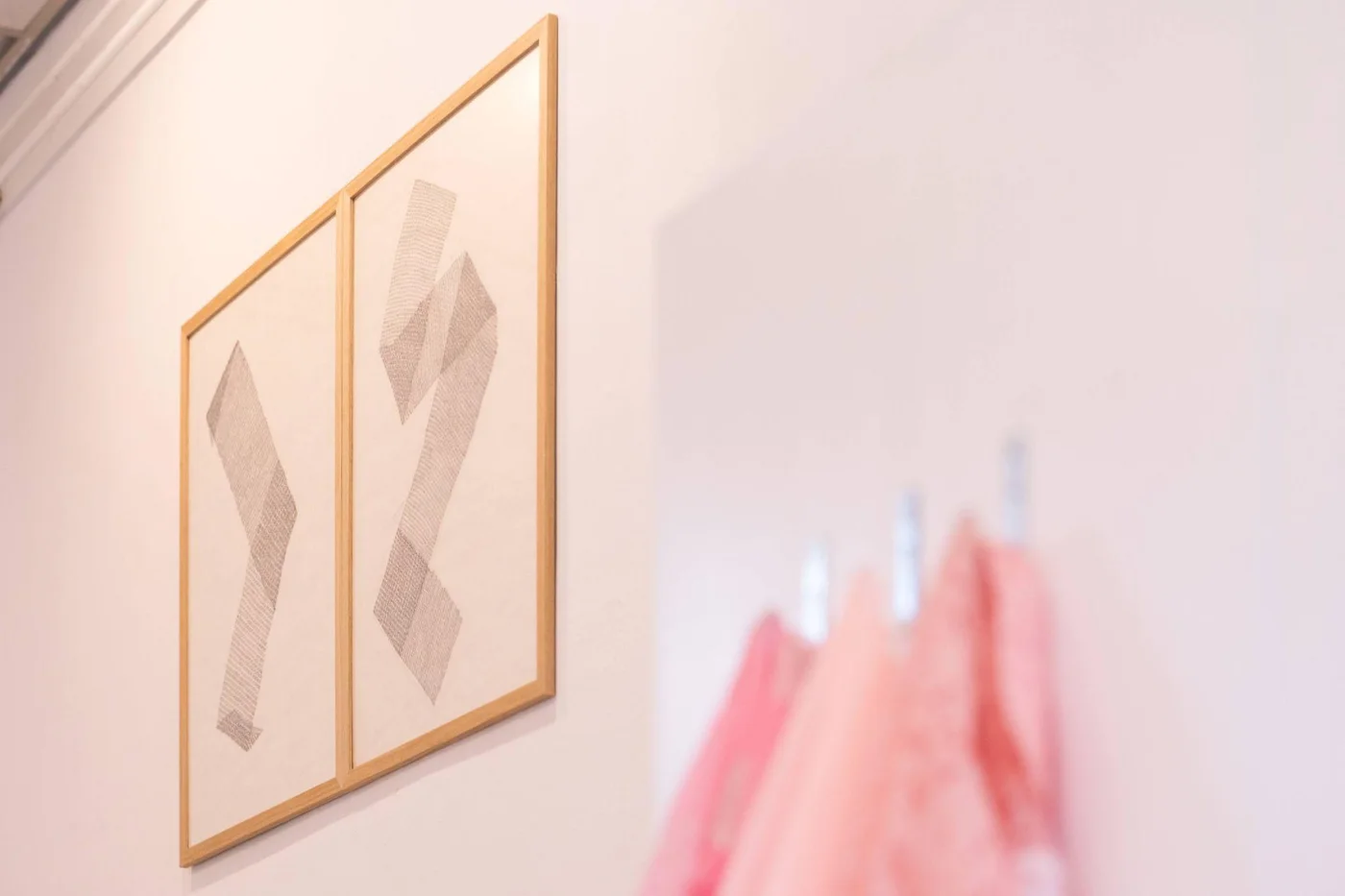 Framed geometric drawings on an exhibition wall