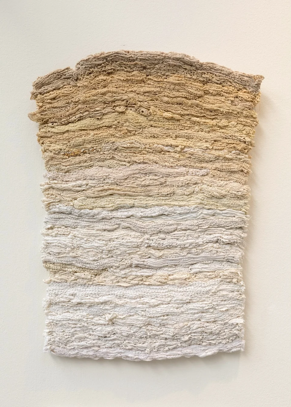 Rectangular textile with horizontal layers of sand and ivory fabric